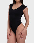 This image features a sleek, black all-day sculpting bodysuit. The bodysuit has a smooth, snug fit that accentuates the figure, with a scoop neck and sleeveless design.