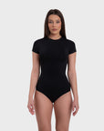This image features a sleek, short sleeve crew neck bodysuit in black. The bodysuit is designed to fit snugly, highlighting a versatile and minimalist style that is suitable for various occasions.