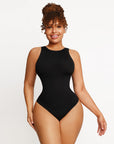 A woman wearing a black halter neck bodysuit.