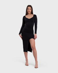 A woman in a black midi dress with a V-neckline and a side slit.
